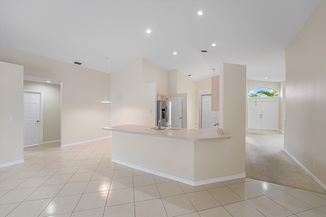 kitchen with lofted ceiling, light carpet, sink, and stainless steel refrigerator with ice dispenser