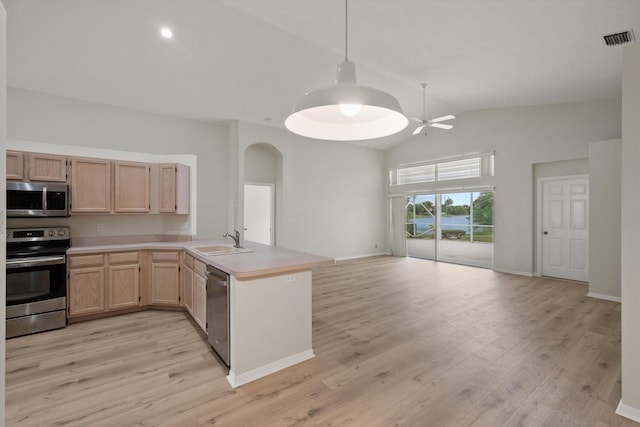 kitchen with sink, decorative light fixtures, light brown cabinets, kitchen peninsula, and stainless steel appliances