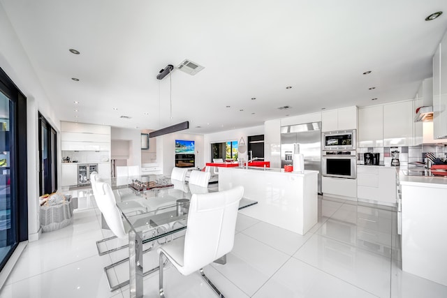 dining space featuring light tile patterned floors