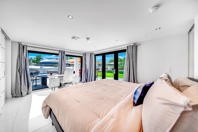 tiled bedroom featuring access to exterior, french doors, and a wall of windows