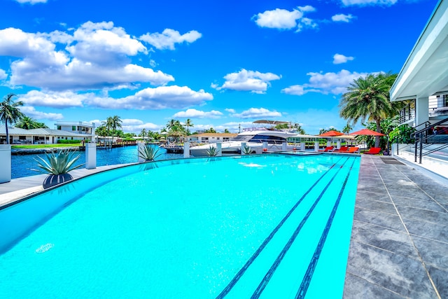 view of swimming pool featuring a water view