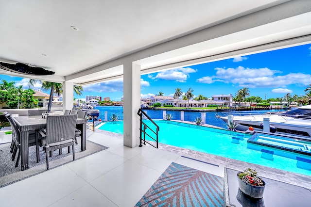 view of pool featuring a water view and a patio