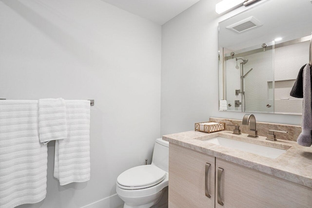 bathroom with vanity, toilet, and walk in shower