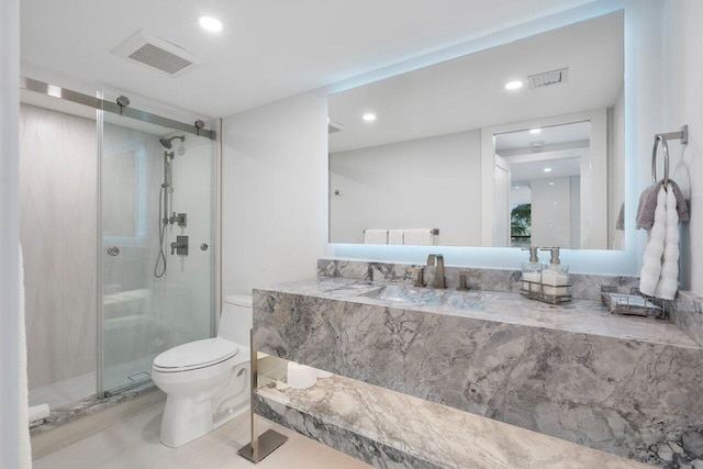 bathroom featuring vanity, toilet, and a shower with door