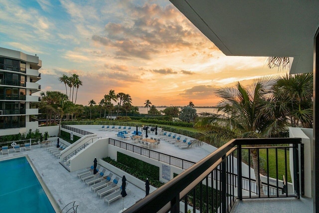 view of pool at dusk