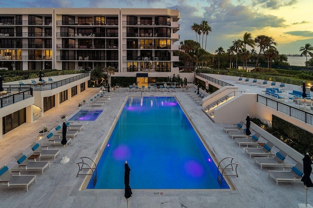 view of pool at dusk