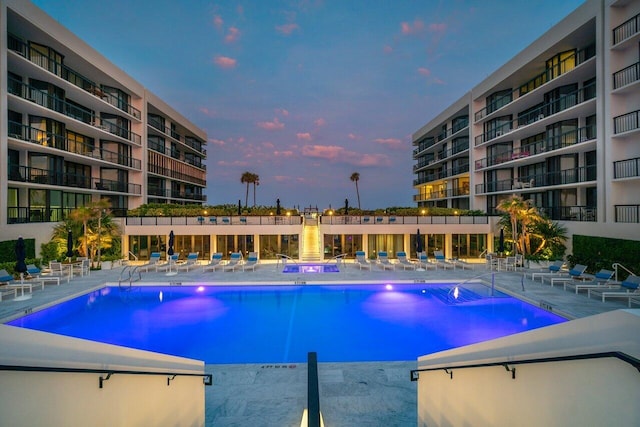 pool at dusk featuring a patio area