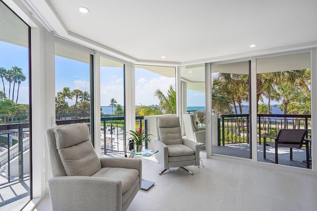 sunroom / solarium featuring a water view