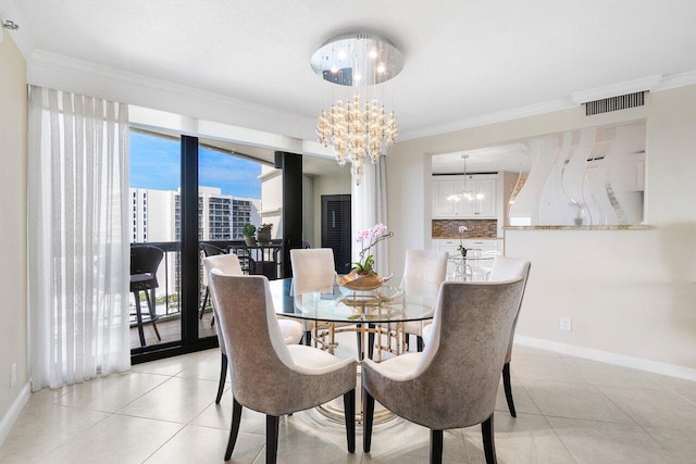 dining area with light tile patterned floors, crown molding, and an inviting chandelier