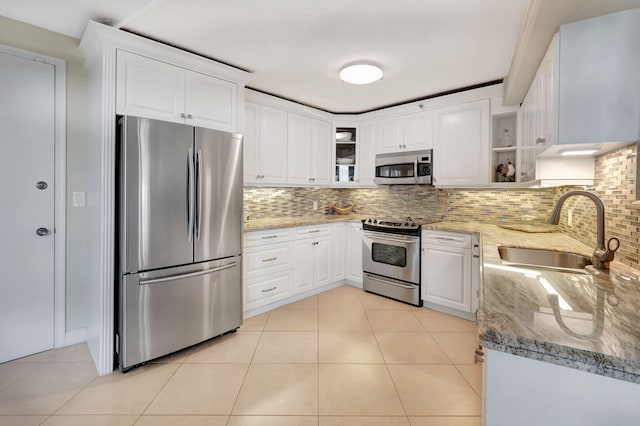 4545 N Ocean Blvd Unit 11C, Boca Raton, FL 33431 - kitchen featuring light stone countertops, appliances with stainless steel finishes, a sink, and tasteful backsplash