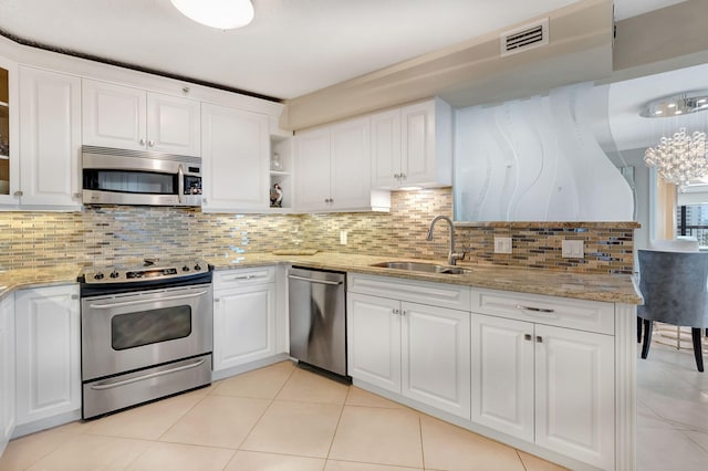 4545 N Ocean Blvd Unit 11C, Boca Raton, FL 33431 - kitchen with stainless steel appliances, light tile patterned floors, white cabinetry, and a sink