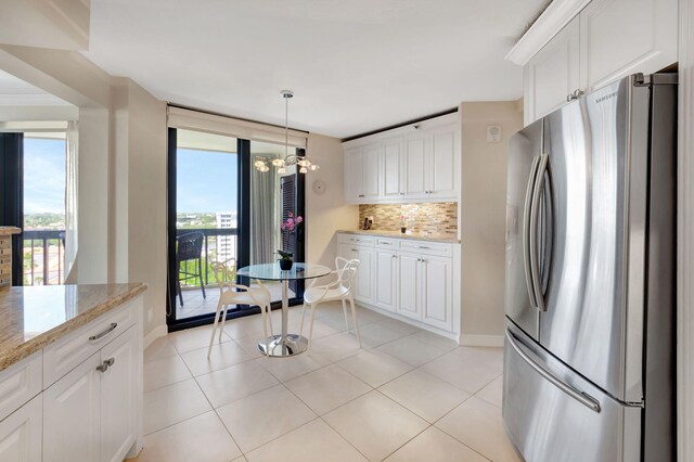 kitchen with backsplash, white cabinetry, and stainless steel appliances