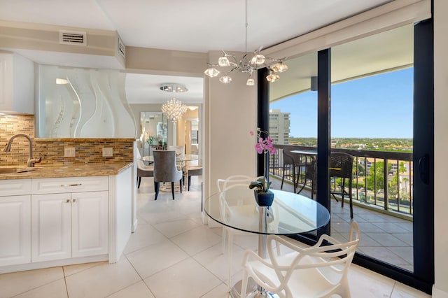 4545 N Ocean Blvd Unit 11C, Boca Raton, FL 33431 - dining area featuring visible vents, light tile patterned flooring, and a notable chandelier