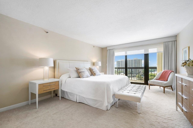 4545 N Ocean Blvd Unit 11C, Boca Raton, FL 33431 - bedroom with access to outside, a textured ceiling, and light colored carpet