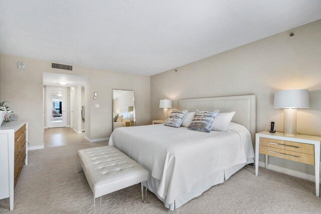 4545 N Ocean Blvd Unit 11C, Boca Raton, FL 33431 - bedroom featuring visible vents, baseboards, and light carpet