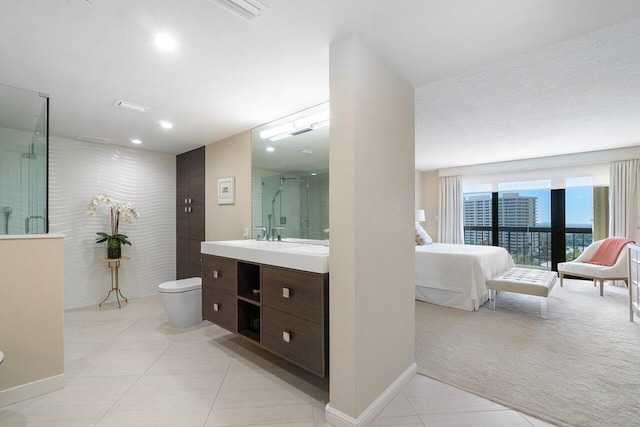 bathroom featuring tile patterned floors, vanity, an enclosed shower, and toilet