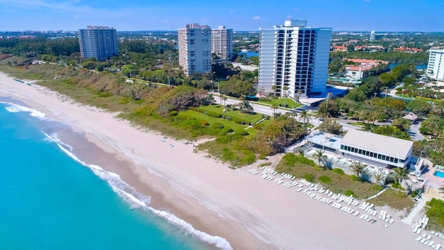 bird's eye view with a water view and a beach view