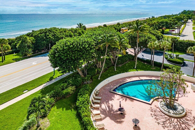 view of pool featuring a view of the beach and a water view