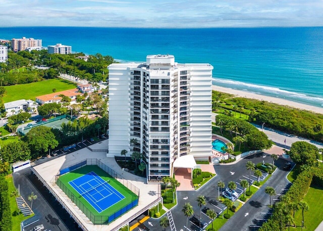 birds eye view of property with a water view and a view of the beach