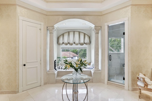 bathroom featuring ornate columns and ornamental molding