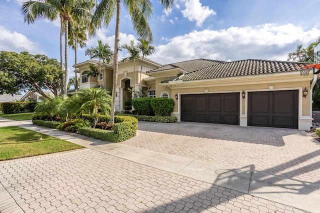 mediterranean / spanish house featuring a garage