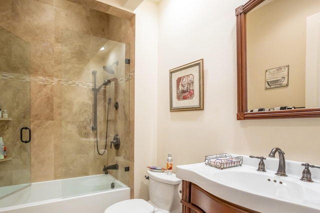 full bathroom with vanity, combined bath / shower with glass door, and toilet