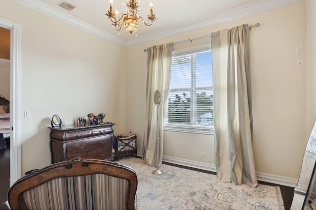 sitting room with ornamental molding and a chandelier