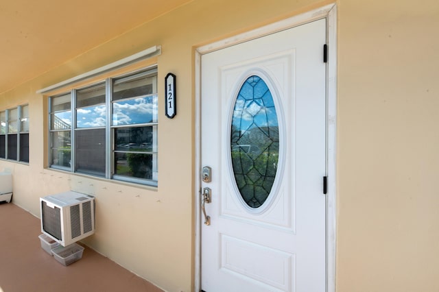 property entrance featuring a wall mounted air conditioner