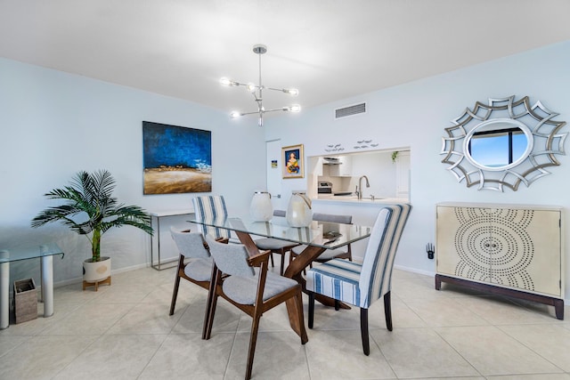 tiled dining area featuring sink and a chandelier