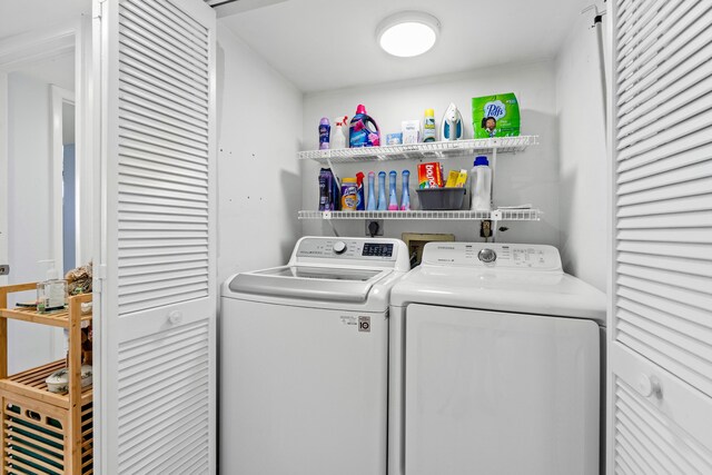 clothes washing area with washing machine and clothes dryer