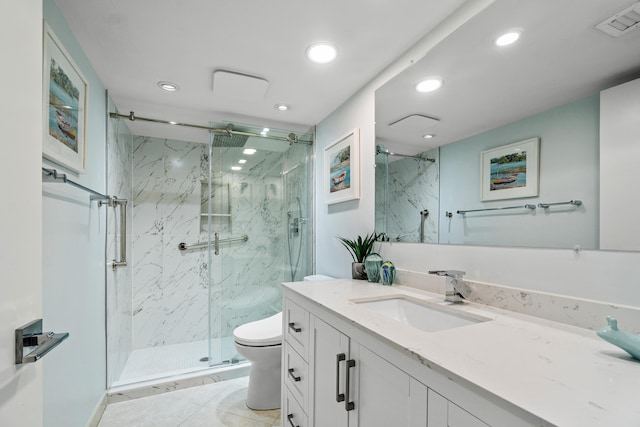 bathroom featuring vanity, toilet, and an enclosed shower