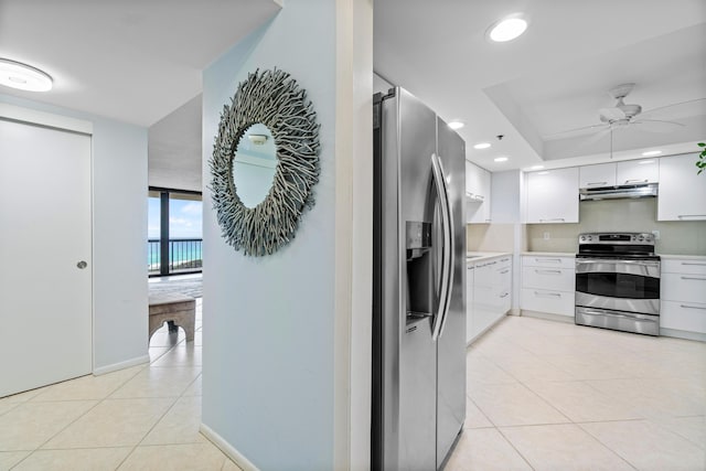 kitchen with white cabinetry, ceiling fan, stainless steel appliances, and light tile patterned flooring