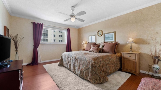 bedroom with ceiling fan, dark wood-type flooring, a textured ceiling, and ornamental molding