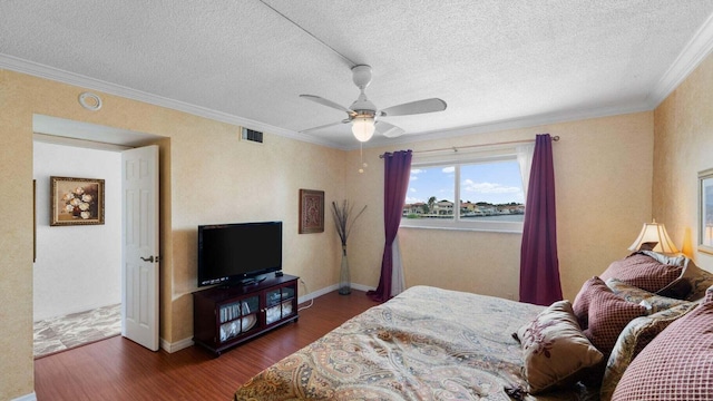 bedroom with dark hardwood / wood-style floors, ceiling fan, crown molding, and a textured ceiling