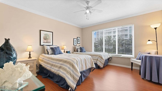 bedroom with wood-type flooring, a textured ceiling, ceiling fan, and ornamental molding