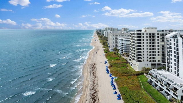 bird's eye view with a water view and a beach view