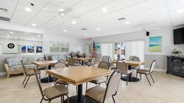 dining space featuring ceiling fan and light tile patterned floors