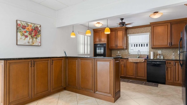 kitchen with a healthy amount of sunlight, hanging light fixtures, ceiling fan, and black appliances