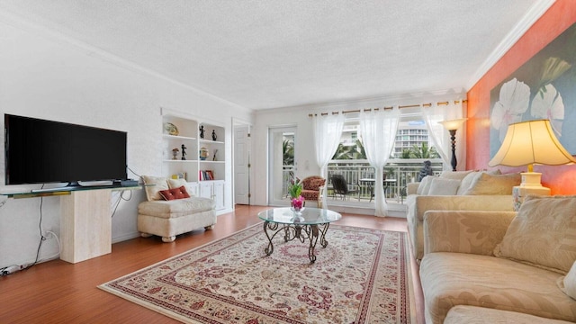 living room featuring crown molding, wood-type flooring, and a textured ceiling