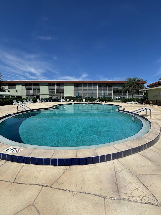 view of swimming pool featuring a patio area