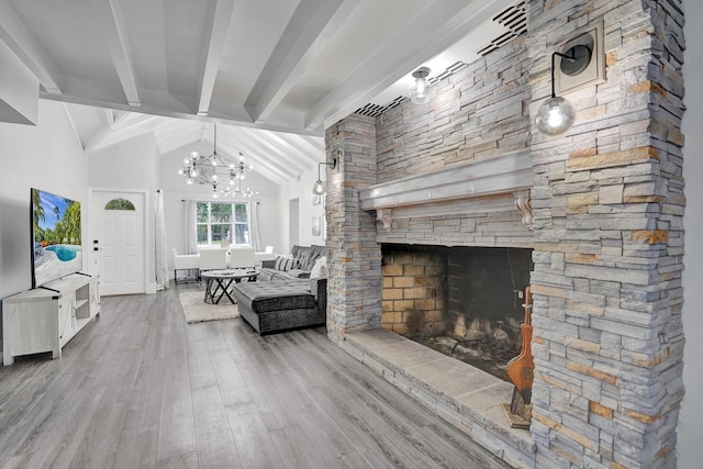 living room featuring beam ceiling, a stone fireplace, high vaulted ceiling, a chandelier, and wood-type flooring