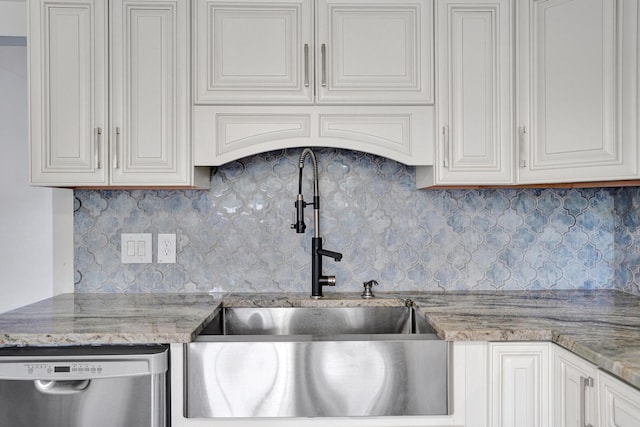 kitchen featuring dishwasher, white cabinetry, decorative backsplash, and sink