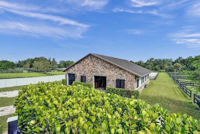 view of side of property with a rural view