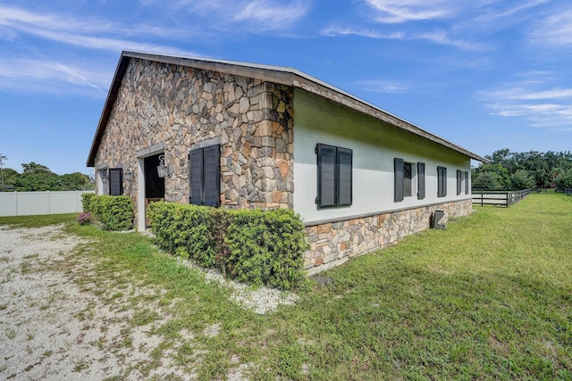 view of side of property featuring a yard