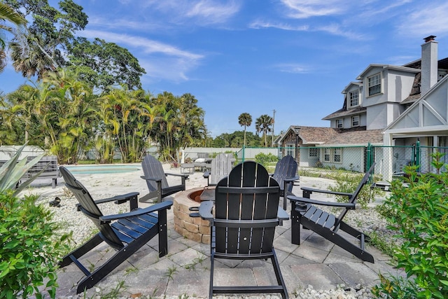 view of patio / terrace featuring a fenced in pool and an outdoor fire pit