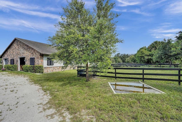 exterior space featuring a yard and a rural view