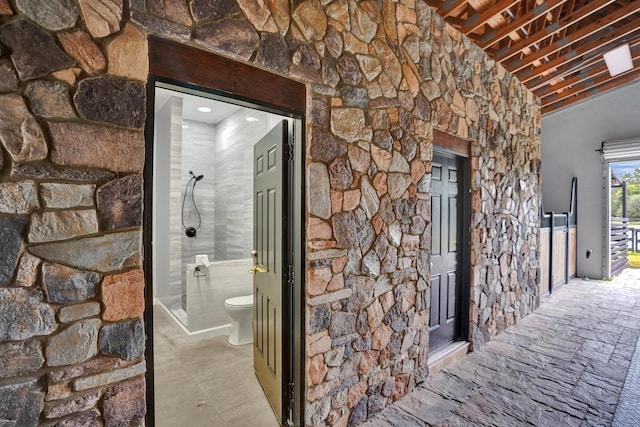 hallway with lofted ceiling with beams