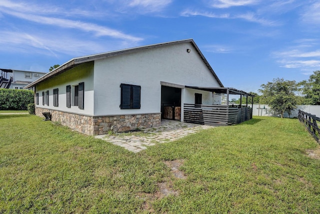 rear view of property featuring a yard