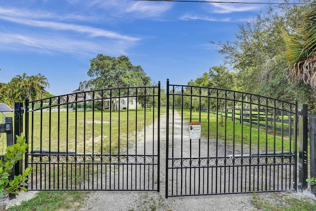 view of gate featuring a lawn