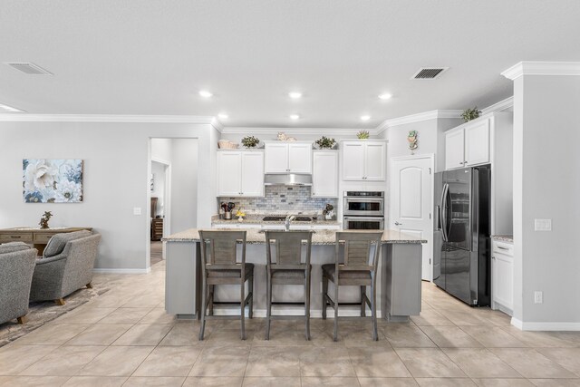 dining space with arched walkways, visible vents, crown molding, and an inviting chandelier